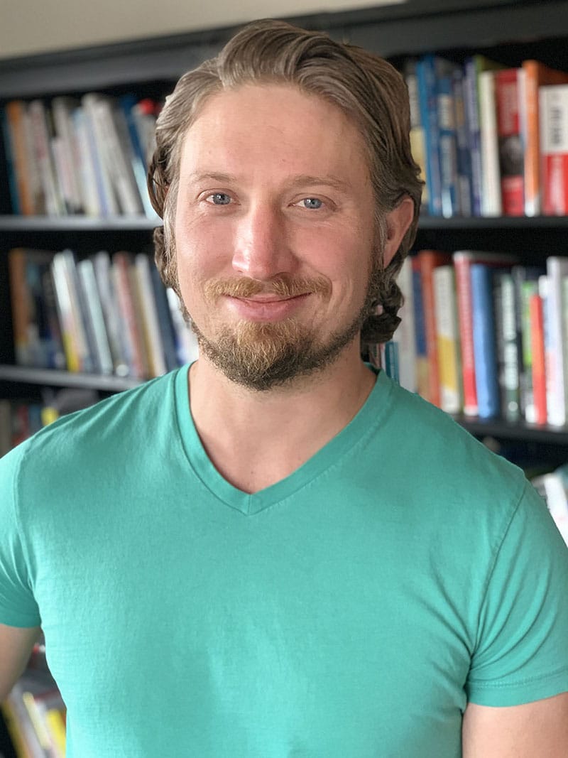 headshot of steven wright against books